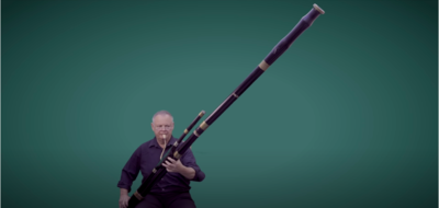 Musician Demonstrates Wide Tonal Range Of Giant Contrabassoon Twice His Size