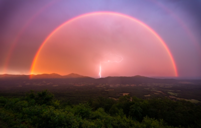 Photographer Captures Incredible Moment Of a Double Rainbow With a Lighting Bolt In The Centre