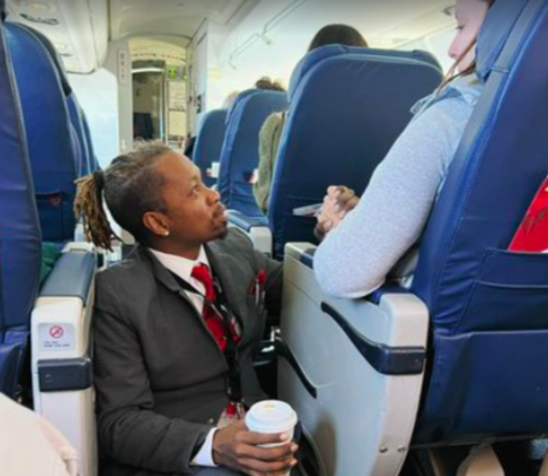 Flight Attendant Sits On Floor To Hold Hand Of Anxious Passenger 1